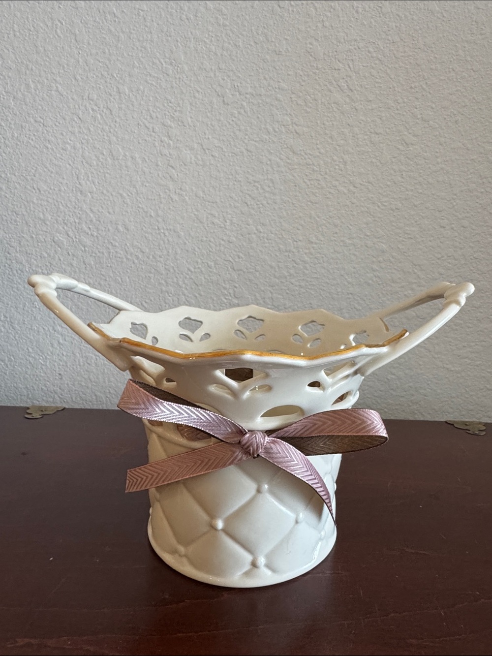 Lenox white ceramic pierced bowl with gold rim and pink ribbon